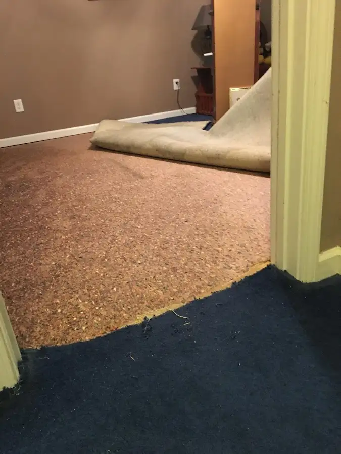 Carpet pad removal revealing water damage during Drying & Dehumidification in Crowley